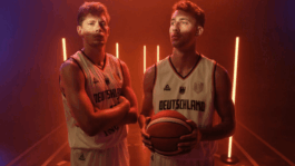 Two people performing on stage under warm red lighting, representing the sound design work for the production Wagner Brothers.